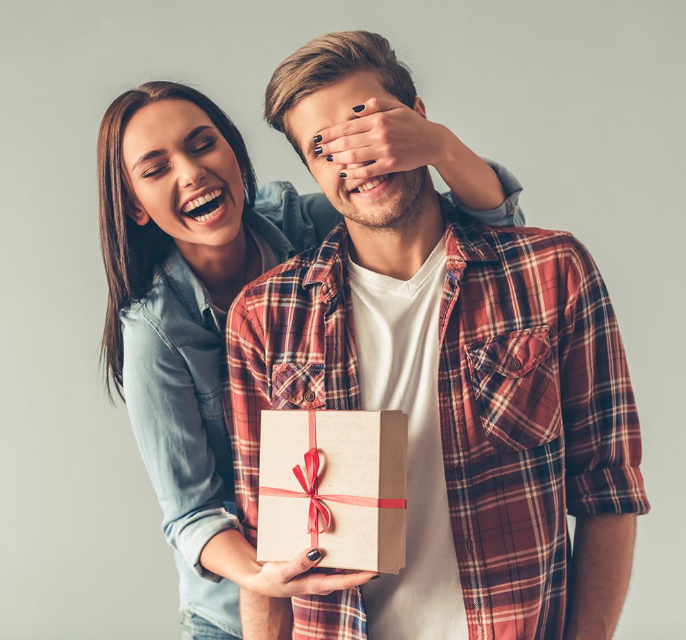man receiving valentine's day gift from girlfriend